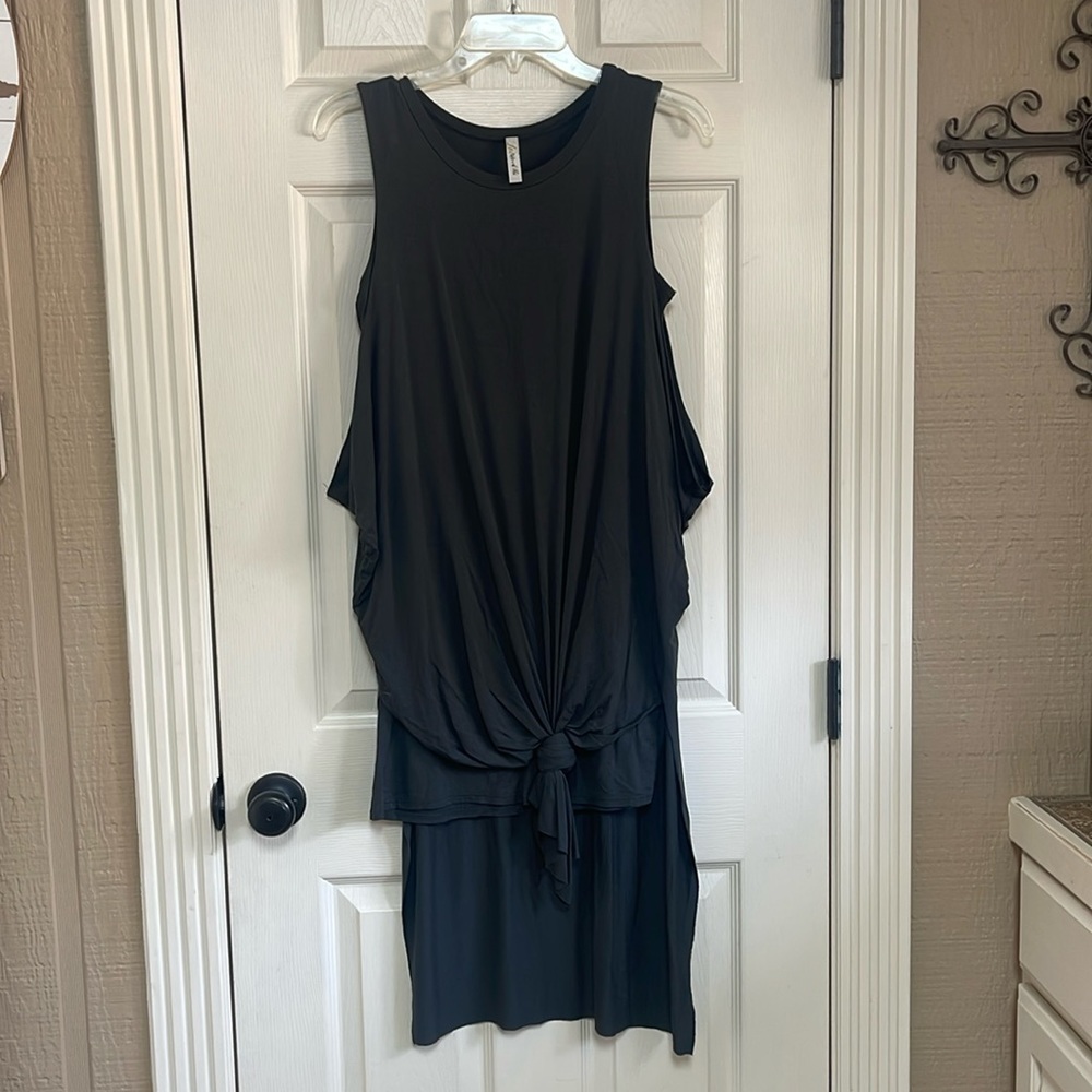 Love In sleeveless dress or top. Shorter front longer back. Great condition. SM